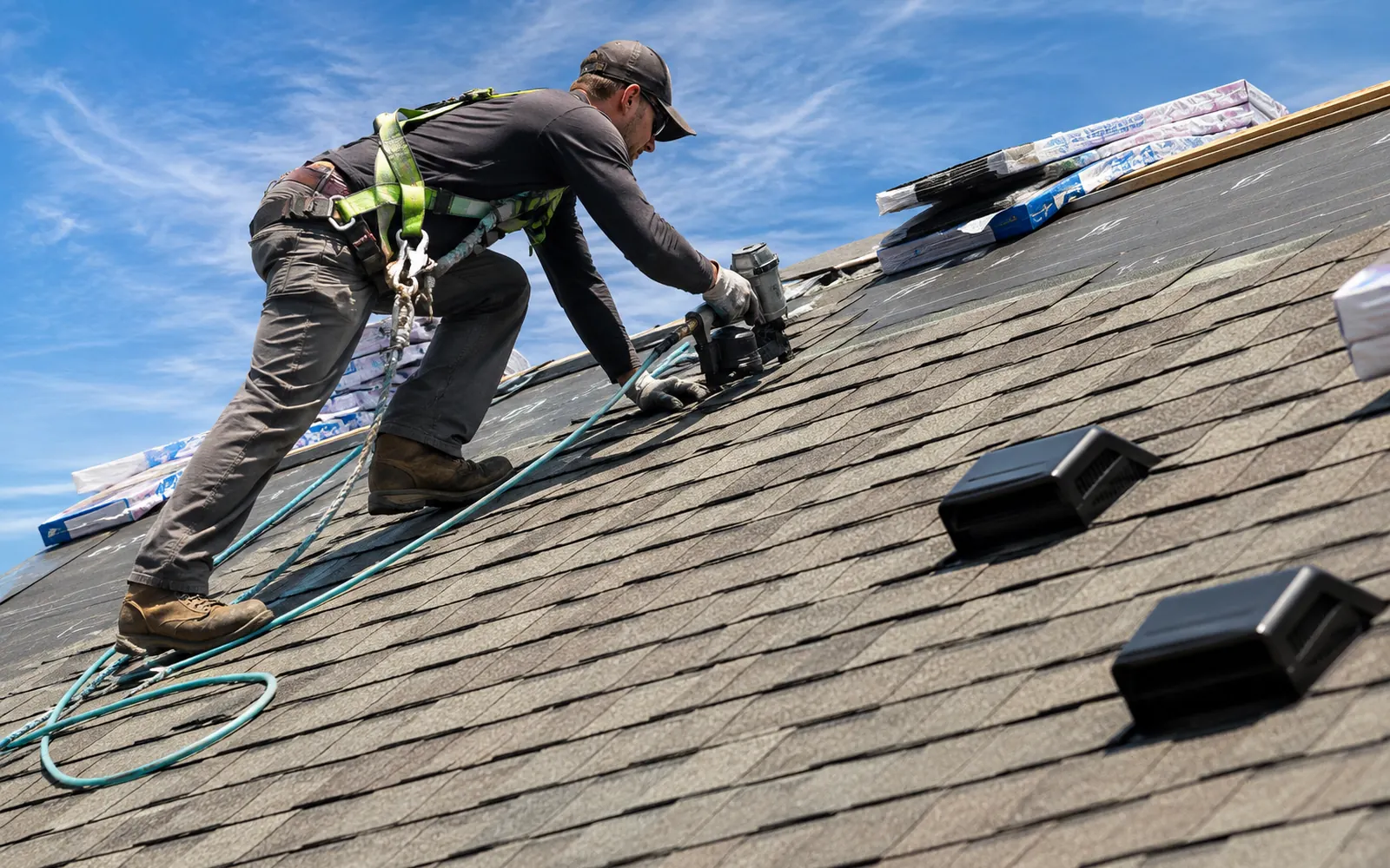 Roofing contractor installing asphalt shingles